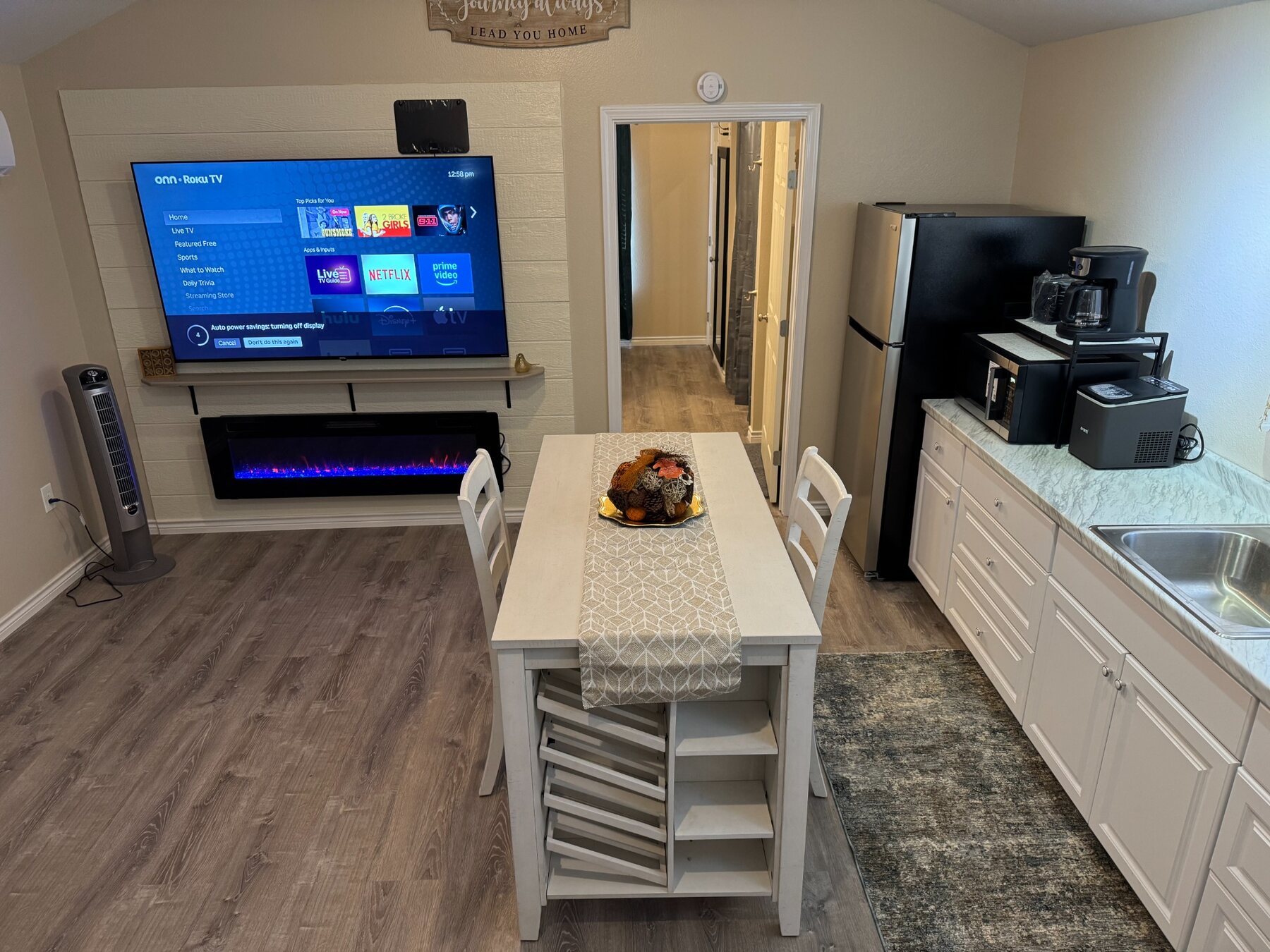 Driscoll A kitchen, dining area and television