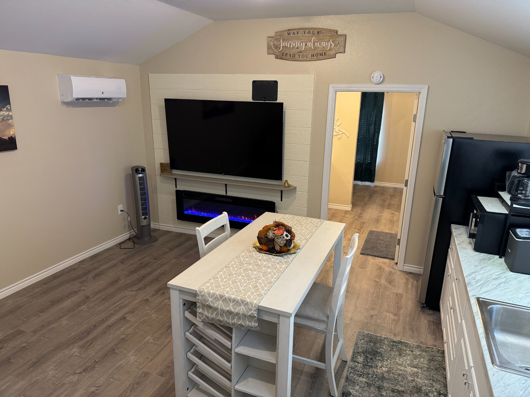 Driscoll A television, kitchen island and living area